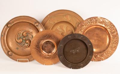 Five embossed copper chargers,