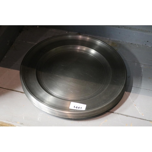 Five heavy pewter plates, each with