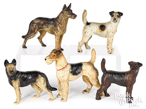 FIVE PAINTED CAST IRON DOG