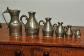 FIVE PEWTER MEASURES AND A FLA