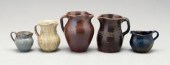 Five pottery pitchers: one wit