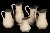 Five saltware jugs, floral dec