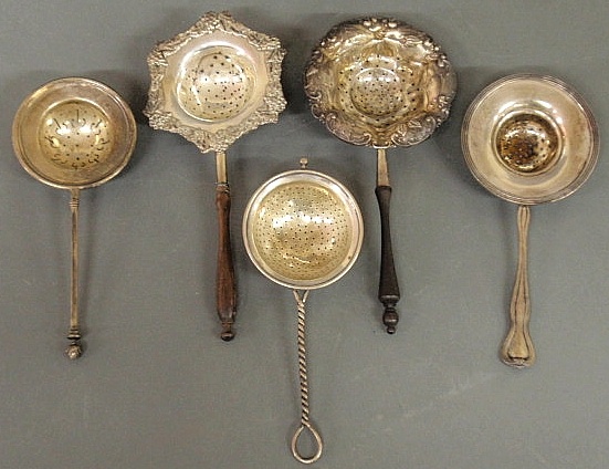 Five silver tea strainers three