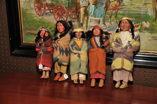 FIVE SKOOKUM DOLLS. Four female