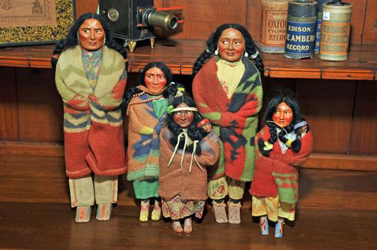 FIVE SKOOKUM DOLLS. Including one