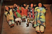 FIVE SKOOKUM DOLLS. Two male f
