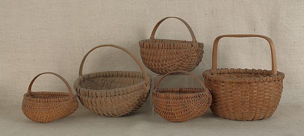 Five split oak baskets largest -