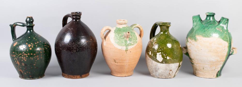 FIVE TALL GLAZED POTTERY JUGS,