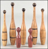 FIVE TURNED WOOD INDIAN CLUBS.