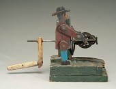 Folk art man turning crank, pa