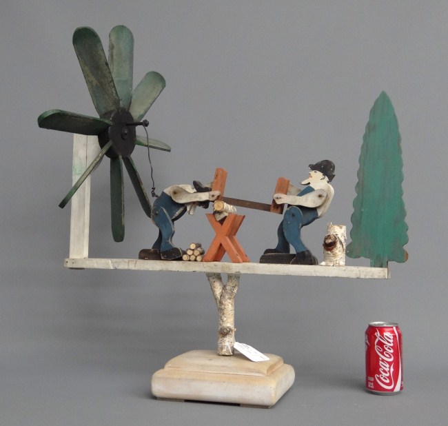 Folk art painted men sawing wood
