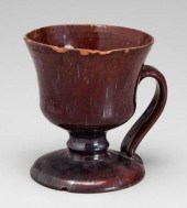Footed redware mug, runny brow