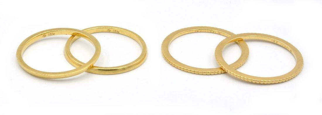 FOUR 18K GOLD BANDS.Four 18K Gold
