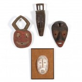 FOUR AFRICAN MASKS OF CARVED W