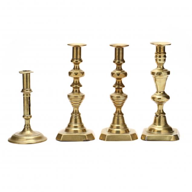 FOUR ANTIQUE BRASS CANDLESTICKS 
