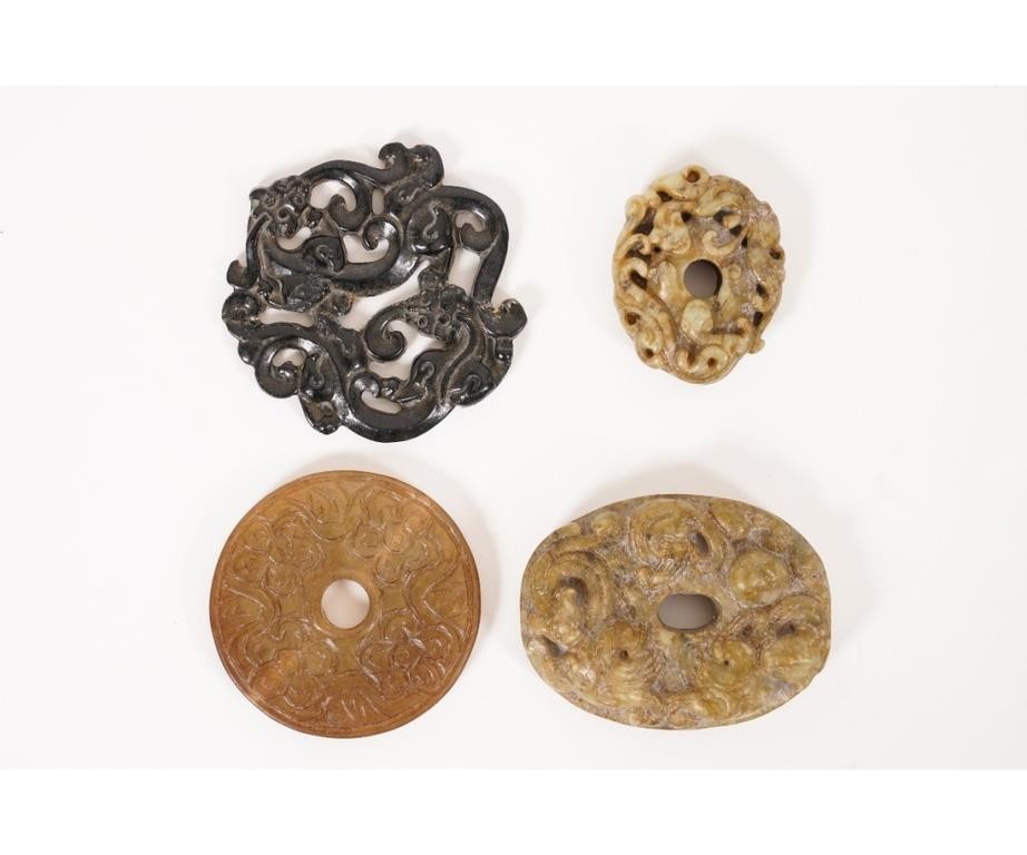 Four Asian stone carved medallions,