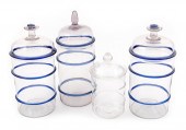 FOUR BLOWN CLEAR GLASS CANISTE