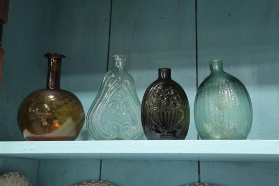 FOUR BLOWN GLASS BOTTLES. A