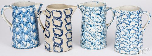 FOUR BLUE SPONGEWARE PITCHERS, 19TH