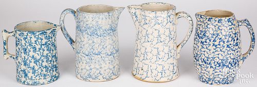 FOUR BLUE SPONGEWARE PITCHERS, 19TH
