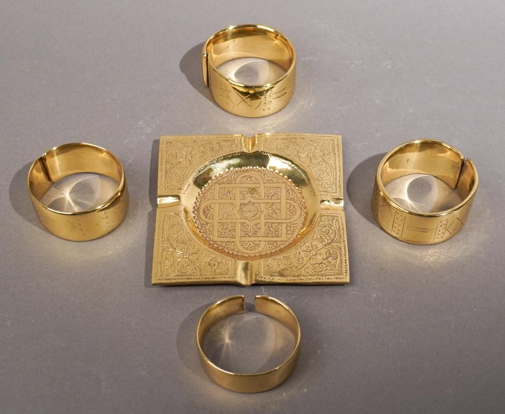 FOUR BRASS BRACELETS AND A BRASS