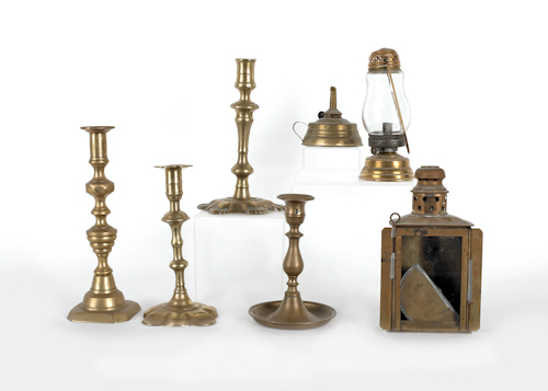 Four brass candlesticks together