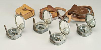 Four Brunton type compasses: each