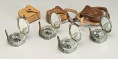 Four Brunton type compasses: e