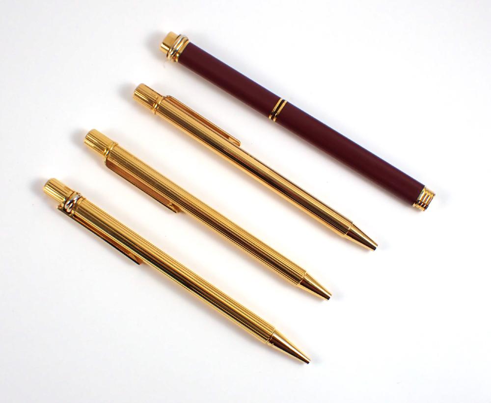 FOUR CARTIER PENS WITH ORIGINAL RED
