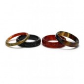 FOUR CARVED STONE BANGLES To i