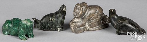 FOUR CARVED STONE FIGURESFour