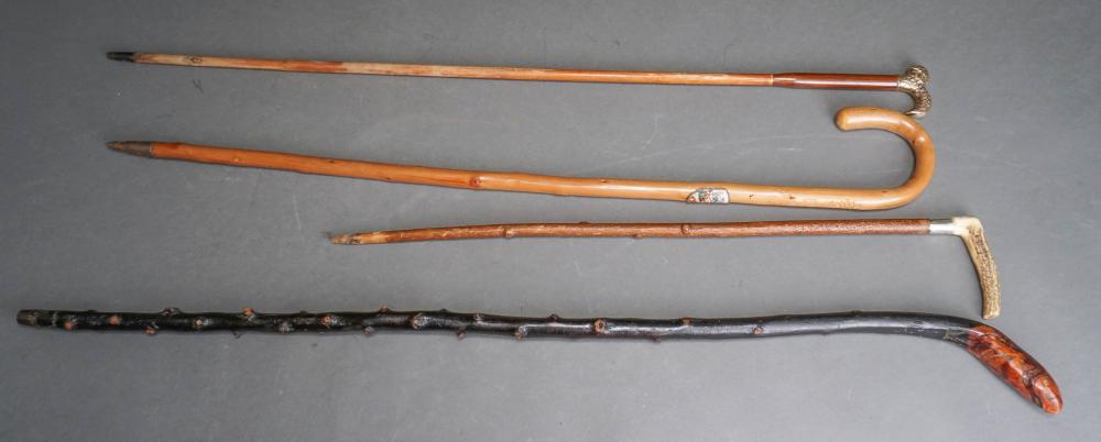 FOUR CARVED WOOD WALKING STICKSFour
