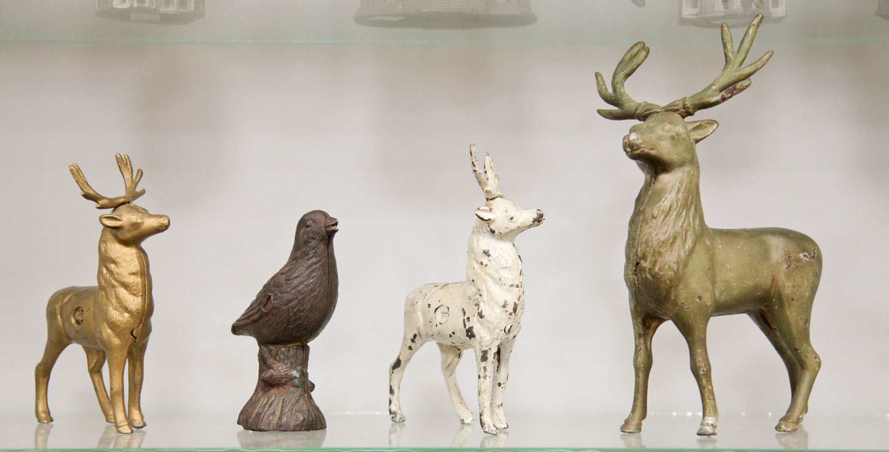 FOUR CAST IRON PENNY BANKS. 