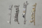 FOUR CHARM BRACELETS. One cowb