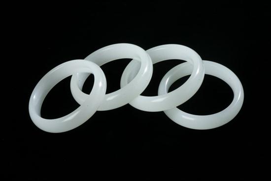 FOUR CHINESE WHITE JADE BANGLES.