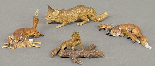 Four cold painted bronze foxes