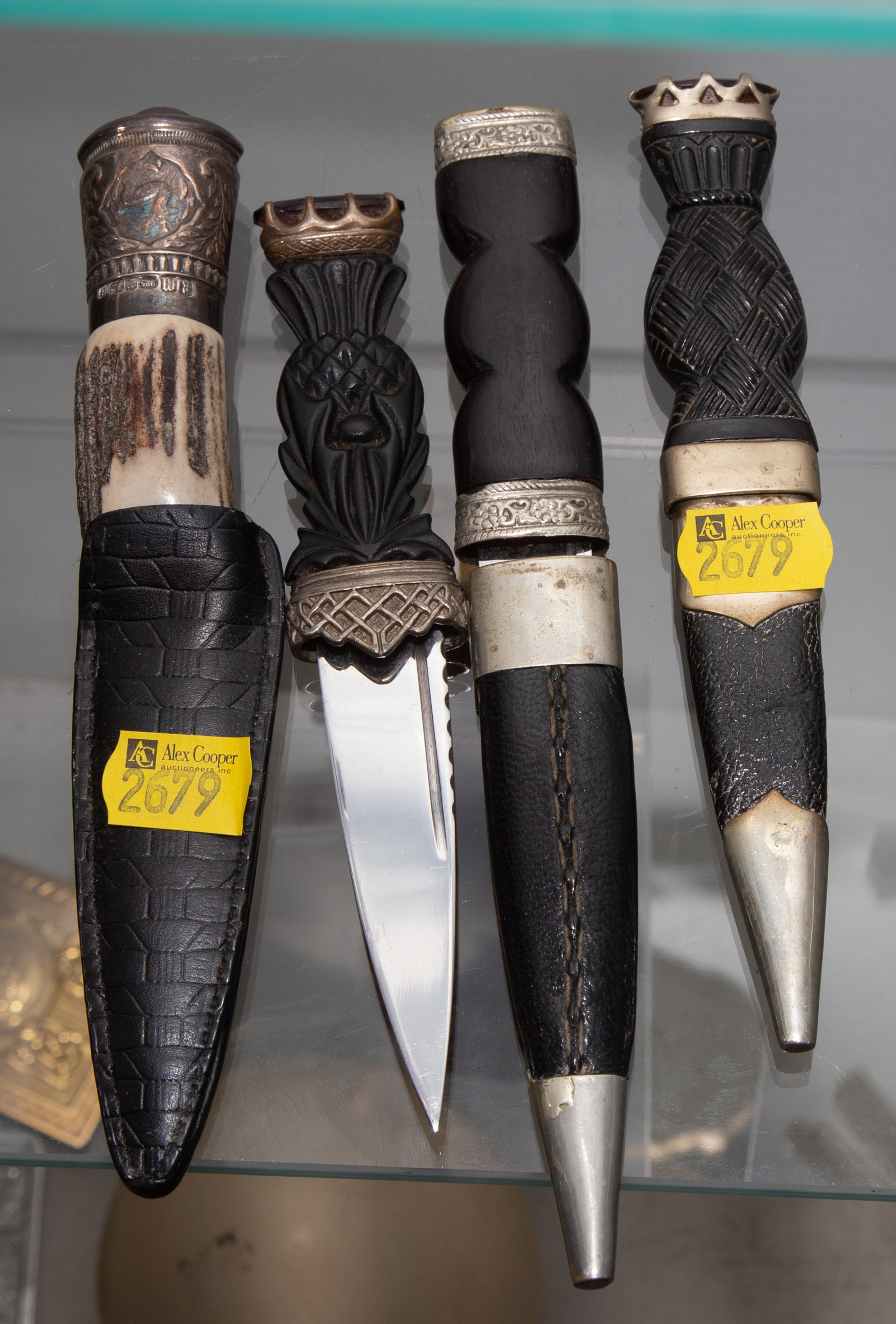 FOUR DECORATIVE SCOTTISH DIRKS .