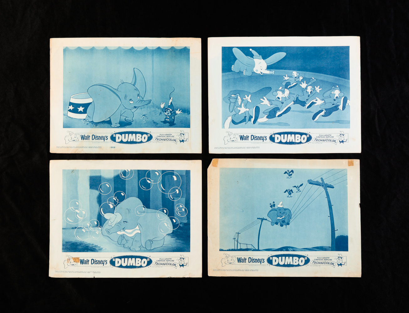 FOUR DUMBO LOBBY CARDS. Buena
