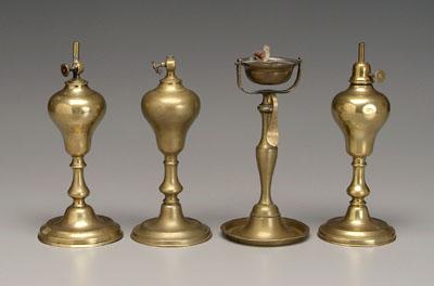 Four early brass lamps: three