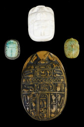 FOUR EGYPTIAN STYLE CARVED STO