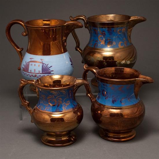Four English copper lustre jugs
