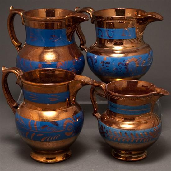 Four English copper lustre jugs