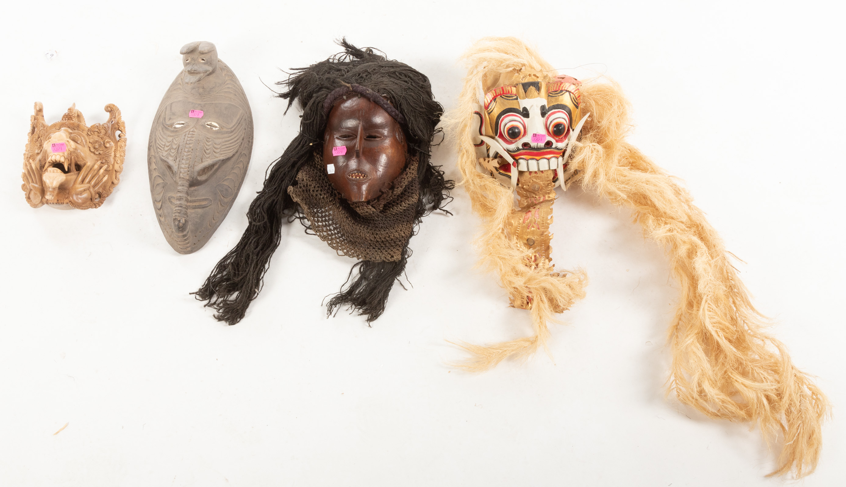 FOUR ETHNOGRAPHIC MASKS Includes