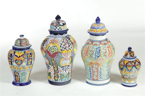 FOUR FAIENCE COVERED JARS. 