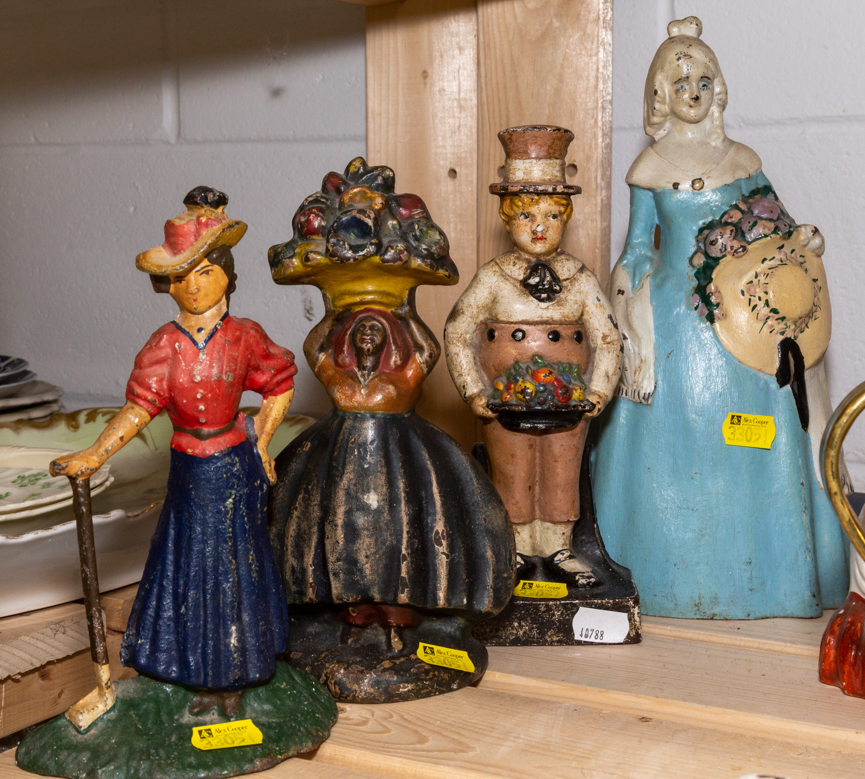 FOUR FIGURAL CAST IRON DOOR STOPS