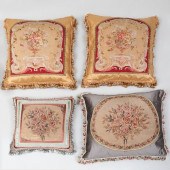 FOUR FLORAL NEEDLEWORK PILLOWS