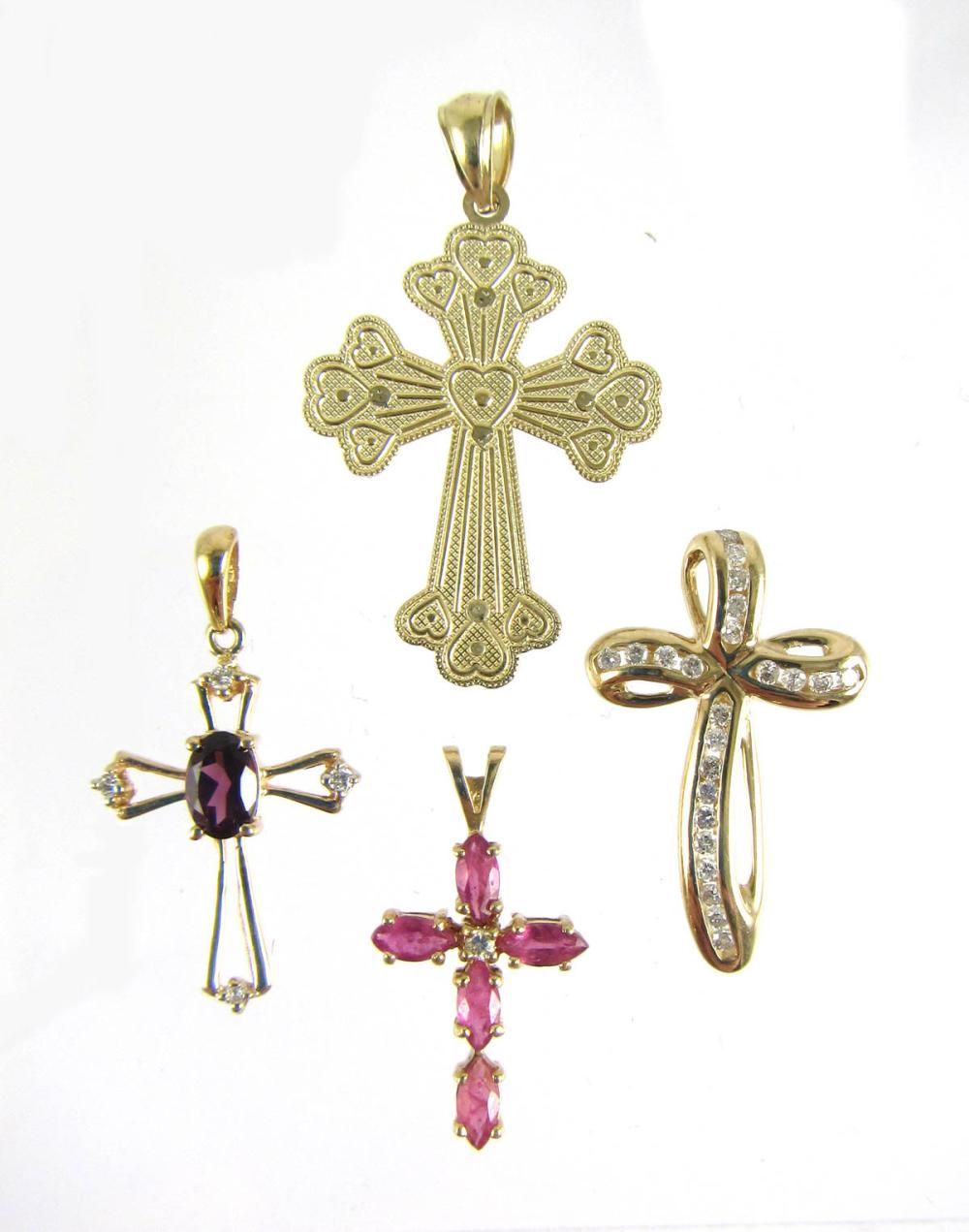 FOUR FOURTEEN KARAT GOLD CROSS