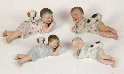 Four German bisque "Piano Baby"