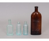 Four glass medicine bottles to