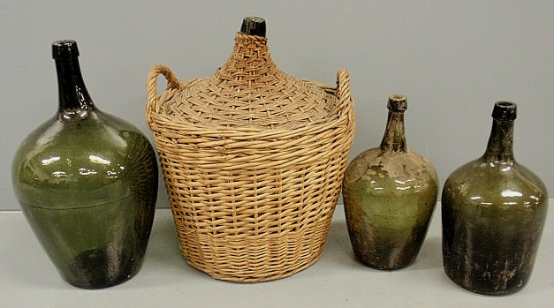 Four green glass bottles largest